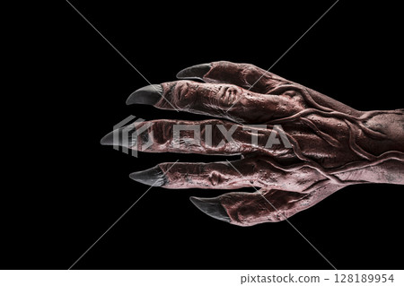 Red devil monster hand isolated on black background with clipping path 128189954