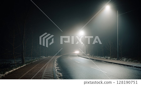 Foggy Road at Night with Headlights and Street Lights Foggy Road at Night with Headlights and Street Lights 128190751