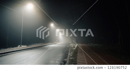 Foggy Road at Night with Headlights and Street Lights Foggy Road at Night with Headlights and Street Lights 128190752
