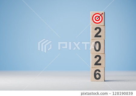2026 new year business concept. Stack of wooden blocks with numbers and target symbol on top against blue background 128190839