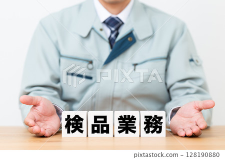中年男性商人穿著工作服和一塊檢查工作 中年男性商人穿著工作服和一塊檢查工作 128190880