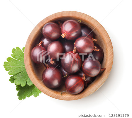 Gooseberries in a wooden plate with leaves on a white background. Top view Gooseberries in a wooden plate with leaves on a white background. Top view 128191379
