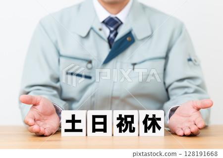 A middle-aged male businessman wearing work clothes and a block of weekends and holidays 128191668