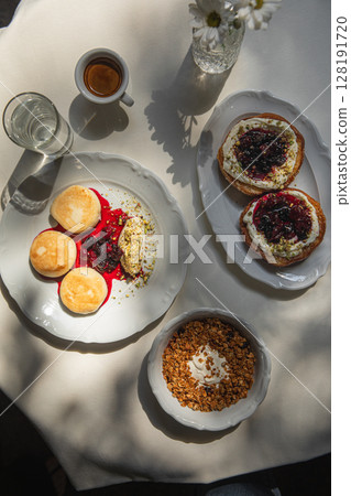 Sweet breakfast with syrniki granola and espresso 128191720