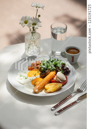 Portion of breakfast with sausage and fried eggs 128191725