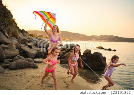Enjoying a colorful day at the beach with family and friends 128191852