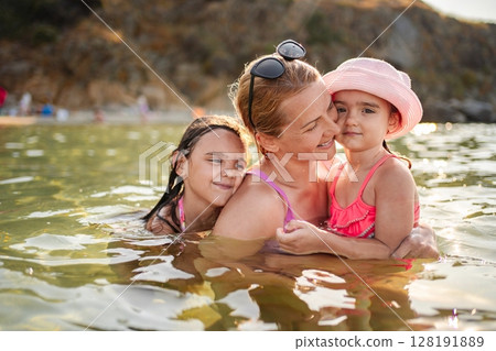 Joyful family moments at the beach on a sunny summer day 128191889