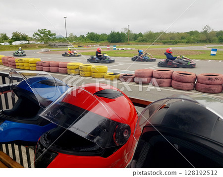 Family Go-Karts outdoors with car helmet 128192512