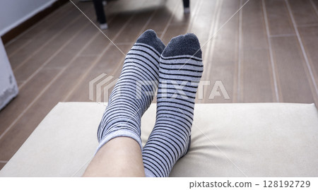Gray socks with black stripes on boys feet 128192729
