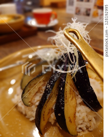 Heaping serving of eggplant curry 128192995