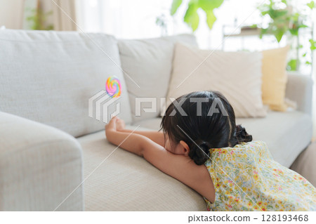 Child eating candy 128193468