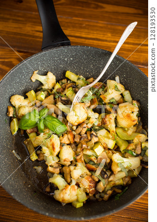 Fried vegetables with greens and cauliflower in oil 128193530