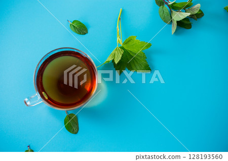 Refreshing herbal infusion in a glass cup and teapot 128193560