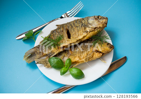 Traditional Ukrainian fried crucian carp in a village kitchen 128193566