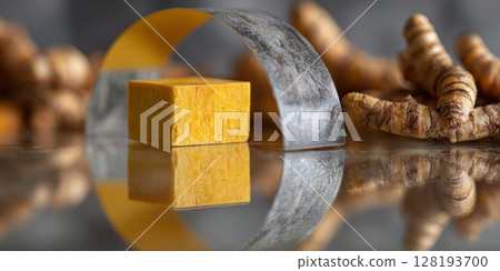 Bright yellow turmeric soap placed within a metallic ring, surrounded by fresh turmeric roots, creating a visually appealing culinary scene Bright yellow turmeric soap placed within a metallic ring, surrounded by fresh turmeric roots, creating a visually appealing culinary scene 128193700