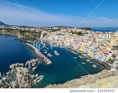 Panoramic view of Corricella a port on Procida, one of the Phlegraean Islands off the coast of Naples in southern Italy. Corricella is known for its vibrantly colorful housing 128193815