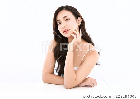 A beautiful young Asian woman with clean, fresh skin against a white background. Skincare, facial treatment, cosmetology, beauty, and spa. An elegant portrait of an Asian woman. A beautiful young Asian woman with clean, fresh skin against a white background. Skincare, facial treatment, cosmetology, beauty, and spa. An elegant portrait of an Asian woman. 128194003