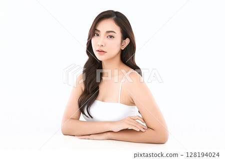 A beautiful young Asian woman with clean, fresh skin against a white background. Skincare, facial treatment, cosmetology, beauty, and spa. An elegant portrait of an Asian woman. A beautiful young Asian woman with clean, fresh skin against a white background. Skincare, facial treatment, cosmetology, beauty, and spa. An elegant portrait of an Asian woman. 128194024