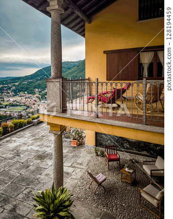 Elegant Italian Courtyard With Traditional Architecture: Cozy Outdoor Lounge And Balcony In A Lombardy Villa 128194459