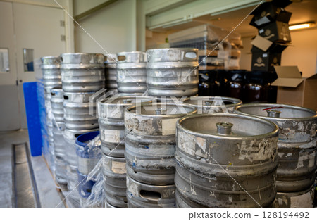 Metal beer kegs stacked in storage room at craft brewery 128194492