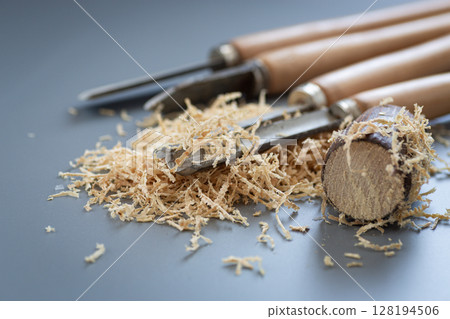 Hand tool and shavings after wood carving 128194506