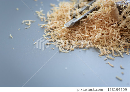 Wood shavings next to chisels on background 128194509