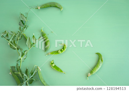 Organic peas with branches on green surface 128194513