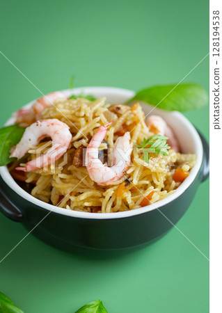 Homemade ceramic dish with vegetable rice and shrimps Homemade ceramic dish with vegetable rice and shrimps 128194538