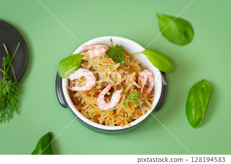 Homemade ceramic dish with vegetable rice and shrimps Homemade ceramic dish with vegetable rice and shrimps 128194583