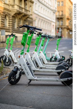 Lime public electric scooters parked in historic centre of Prague, capital of Czech Republic 128195368