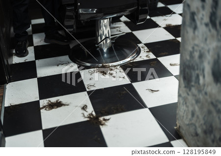 Hair strands scattered on the floor of a trendy barbershop in the city Hair strands scattered on the floor of a trendy barbershop in the city 128195849