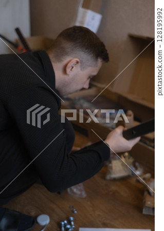 Home handyman assembling fitness equipment for effective workouts without leaving the house. 128195992