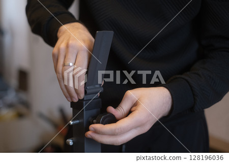 Professional assembling new furniture at home repairing and installing furniture with skill and care. Professional assembling new furniture at home repairing and installing furniture with skill and care. 128196036