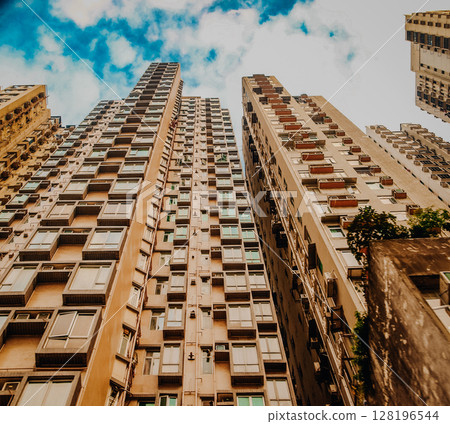 Dense High-Rise Residential Buildings In Hong Kong: Towering Urban Skyline With Layers Of Modern Apartments Under A Cloudy Sky In One Of The Worlds Most Populated Cities. 128196544