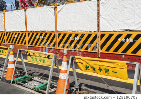 Guard fence at a construction site [Construction, civil engineering, and construction management image] 128196702