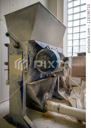 Close-up of malt mill machine used in beer brewing process at craft brewery Close-up of malt mill machine used in beer brewing process at craft brewery 128196710