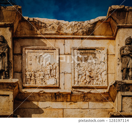 Stone Relief Carvings At The Ruins Of St. Pauls In Macau: Historic Facade Featuring Intricate Biblical Scenes And Sculptures On Weathered Colonial Architecture Under Deep Blue Sky 128197114