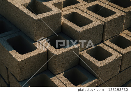 Stack of hollow concrete blocks arranged in sunlight, construction materials for building industrial infrastructure, AI Generative Stack of hollow concrete blocks arranged in sunlight, construction materials for building industrial infrastructure, AI Generative 128198780