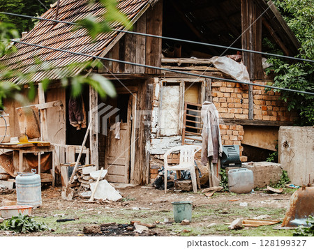 Improvised Housing With Makeshift Structures And Scattered Debris: A Scene Depicting Poverty, Unstable Living Conditions, And Everyday Struggles In An Urban Slum Environment. 128199327