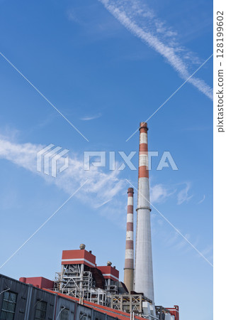 Chimney under blue sky and white clouds 128199602