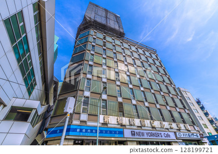 Tokyo cityscape in Japan - View of the demolition work of rooftop advertisements at Shinbashi Station Building No. 2 128199721