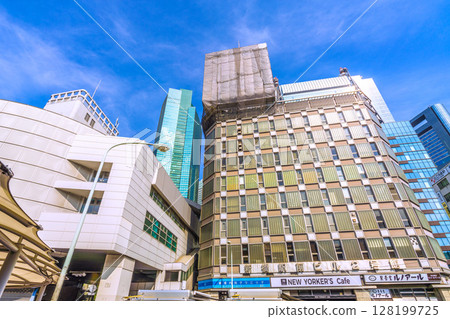 Tokyo cityscape in Japan - View of the demolition work of rooftop advertisements at Shinbashi Station Building No. 2 128199725