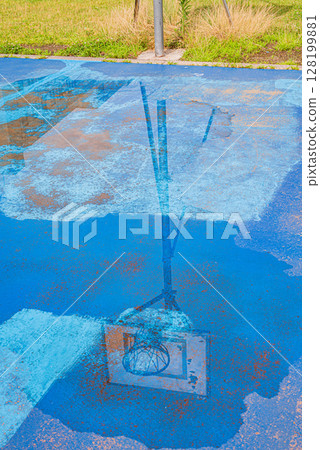 Basketball goal reflected in a puddle Basketball goal reflected in a puddle 128199881