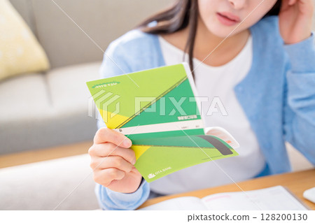 A woman holding a household account book 128200130