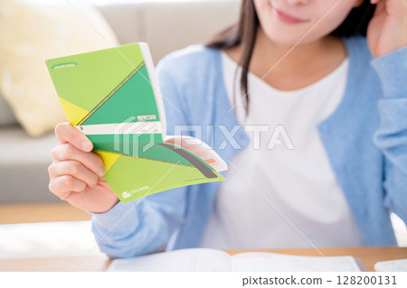 A woman holding a household account book 128200131