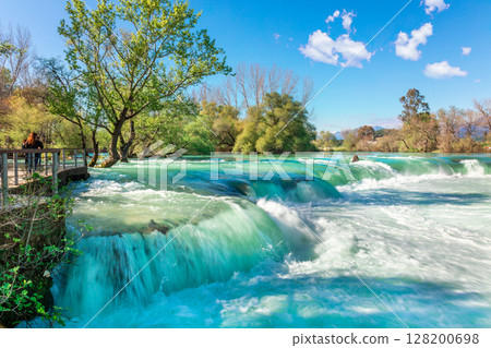 Beautiful natural landscape of Manavgat waterfall in national park on sunny spring day. Unique azure water color with splashes, Side, Antalya,Turkey. High quality photo 128200698