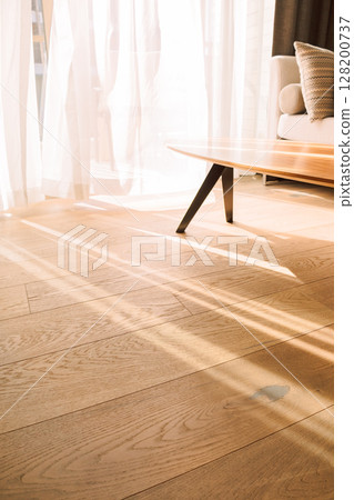Modern room interior with an open window in minimal style. Transparent tulle with morning sun rays on shadow background. Vertical photo. Modern room interior with an open window in minimal style. Transparent tulle with morning sun rays on shadow background. Vertical photo. 128200737