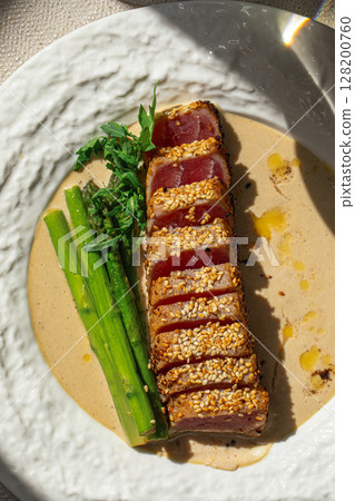 Grilled sliced tuna with asparagus and sesame Grilled sliced tuna with asparagus and sesame 128200760