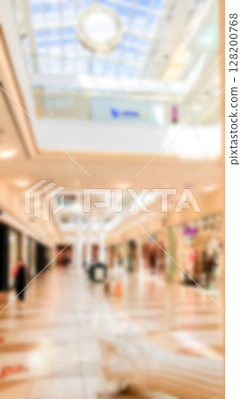 Abstract blur modern shopping center. Mall high fashion on light defocus background. Vertical photo. 128200768