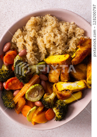 This breakfast bowl features quinoa, baked sweet potato, carrots, zucchini, broccoli, beans, baked chicken with turmeric,perfect for an energizing morning This breakfast bowl features quinoa, baked sweet potato, carrots, zucchini, broccoli, beans, baked chicken with turmeric,perfect for an energizing morning 128200797